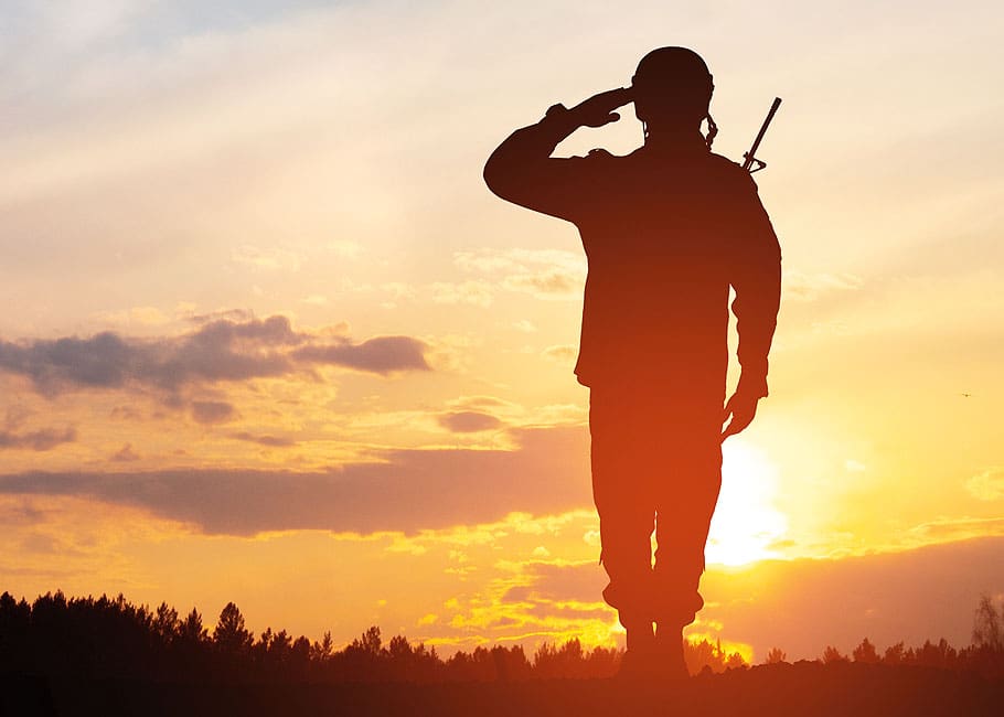 a soldier saluting the Canadian flag