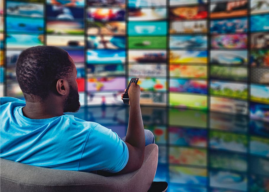 person watching multiple TV screens