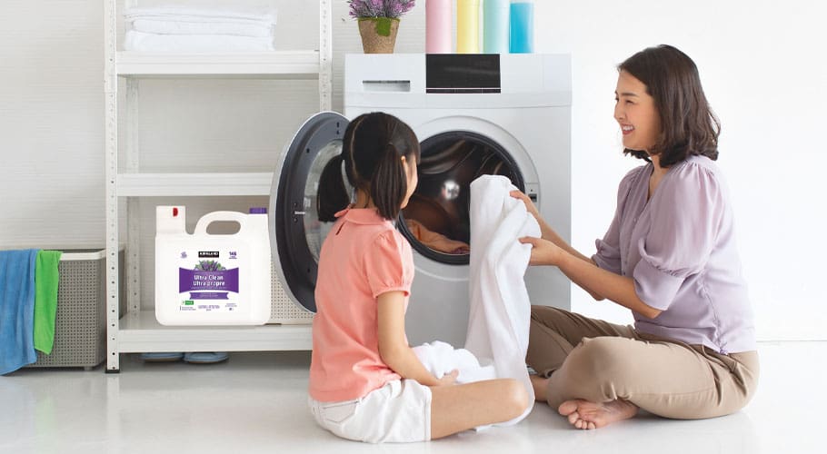 Parent and child doing laundry together