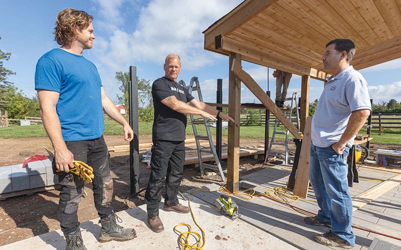 Three people discussing home renovation
