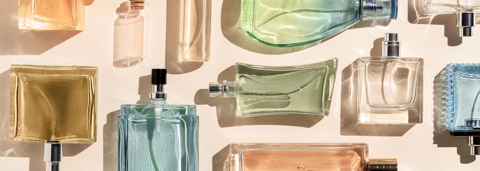 Multiple fragrance bottles in different shapes and colours.