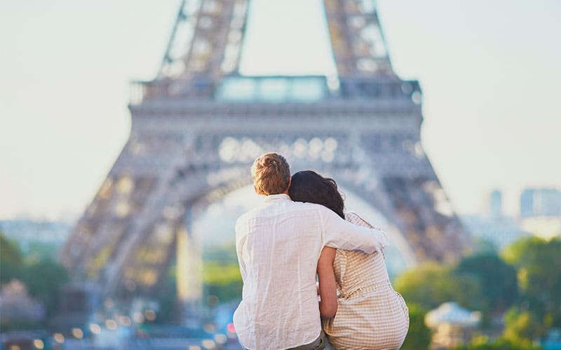 a couple looking at the Eiffel Tower