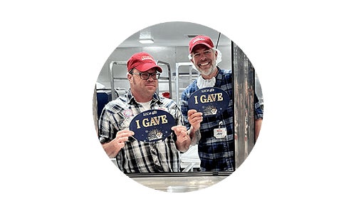 Smiling Costco employee helping to box members' products at Costco warehouse