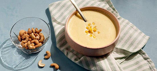 bowl of cashews next to bowl of soup