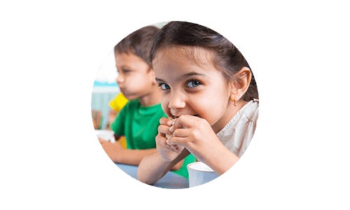 Children eating a healthy snack at table