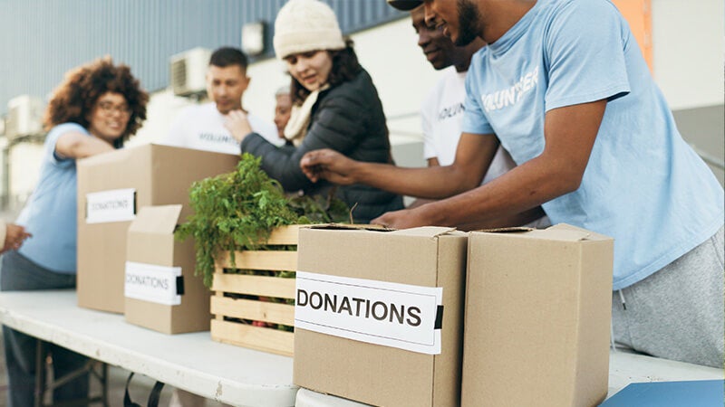 Volunteers managing a donations table at a community event