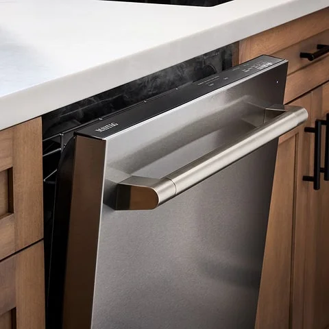 Stainless steel dishwashers slightly opened underneath kitchen counter