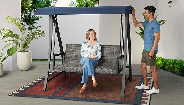 Woman lounging on outdoor funiture swing
