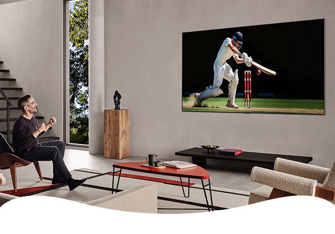 Man sitting in living room watching TV