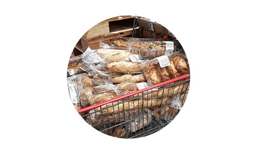 Costco cart full of Costco food donations bread for community - charitable giving
