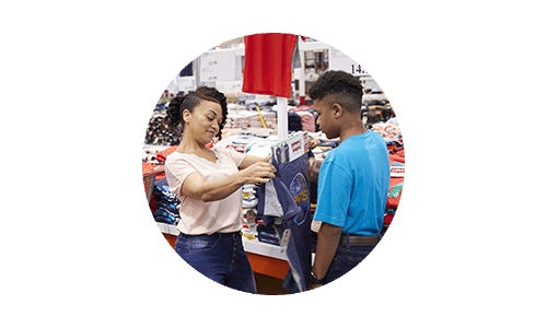 Costco members mom and son shopping for back to school clothing at Costco warehouse