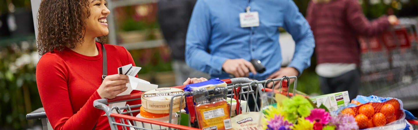 Costco shopper with full cart of products at Costco warehouse